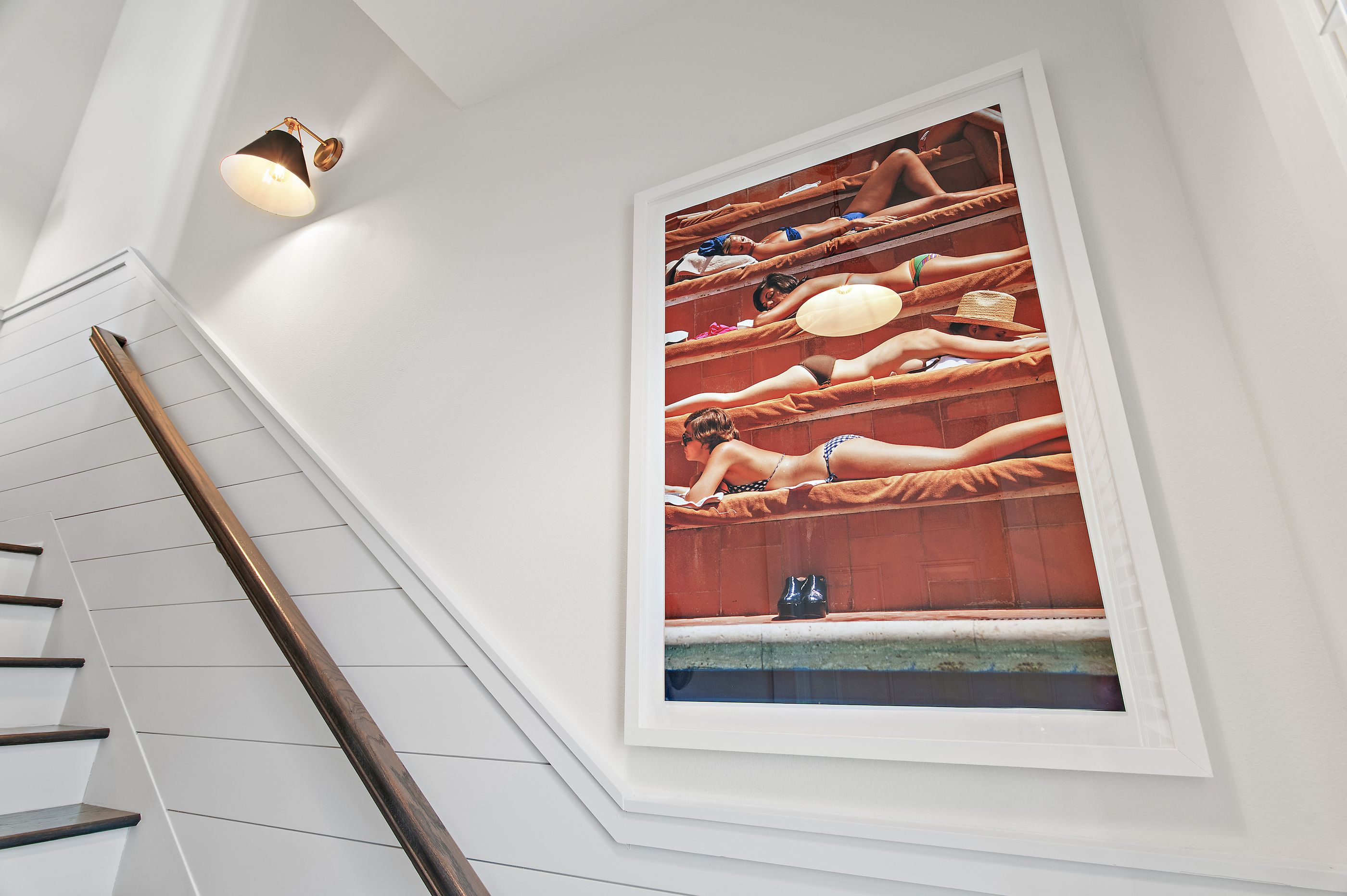 Staircase with coastal artwork